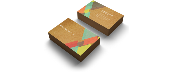 2 stacks, the front and back, of brown business cards, featuring cyan, red, yellow and brown triangular designs atop the cards decks. Represents 400gsm Kraft line of business cards from Hatch.