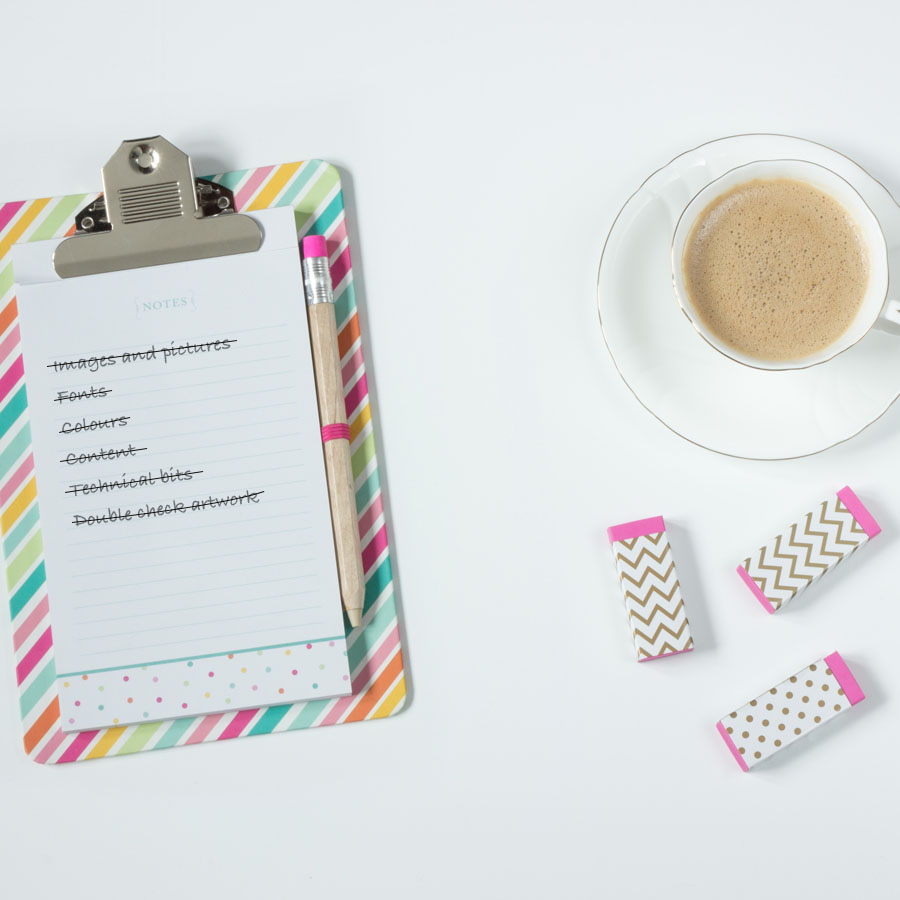 White background with a cup of tea, 3 pink erasers and a rainbow-striped clipboard holding a brown pencil and white notepad. On the pad, a list of the 6 most common design mistakes, all items on the list have a line through.
