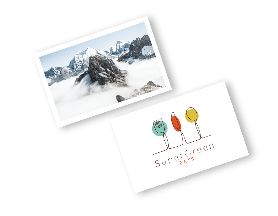 Example white business card featuring image of mountains, and another white business card with stylised green, red and yellow cutlery with 'SuperGreen, Eats' text in black text. Some of the design options for you to stand out with a beautiful business card.