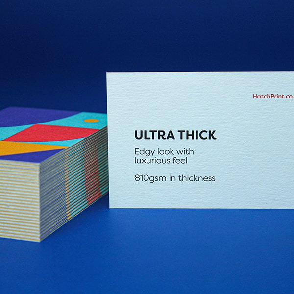 2 white business cards out-lined in blue. The left card contains a square in the upper left and copy 'Name here, Job title here' on the right. The other card contains a large upward facing arrow within a circle. It represents the first step when ordering with Hatch: select your product.